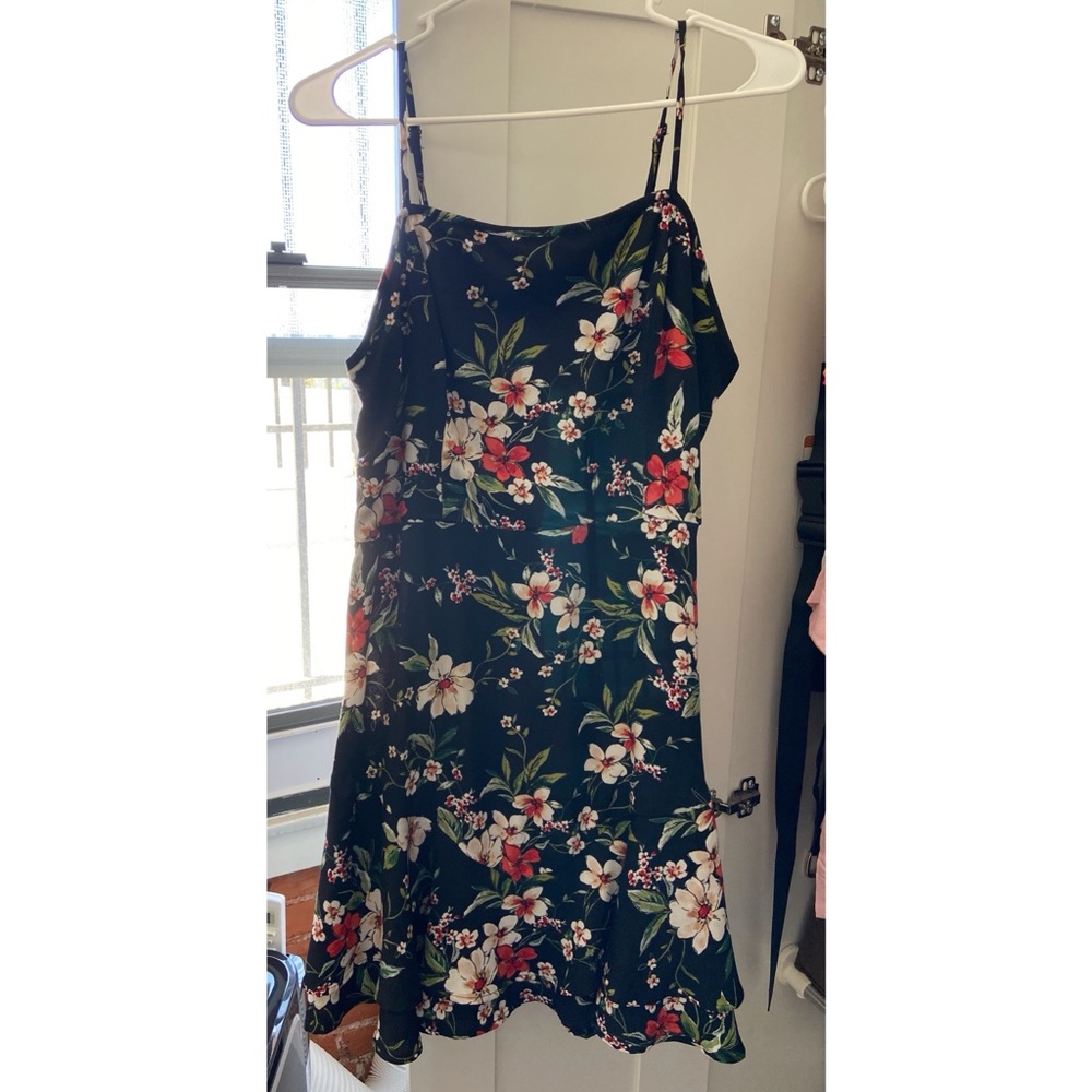 Floral adjustable spaghetti strap dress with double layer flowy hem.
